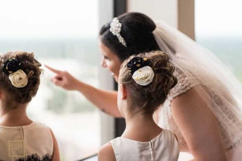 Bride and flowergirls look out the window at Citrus Club Wedding
