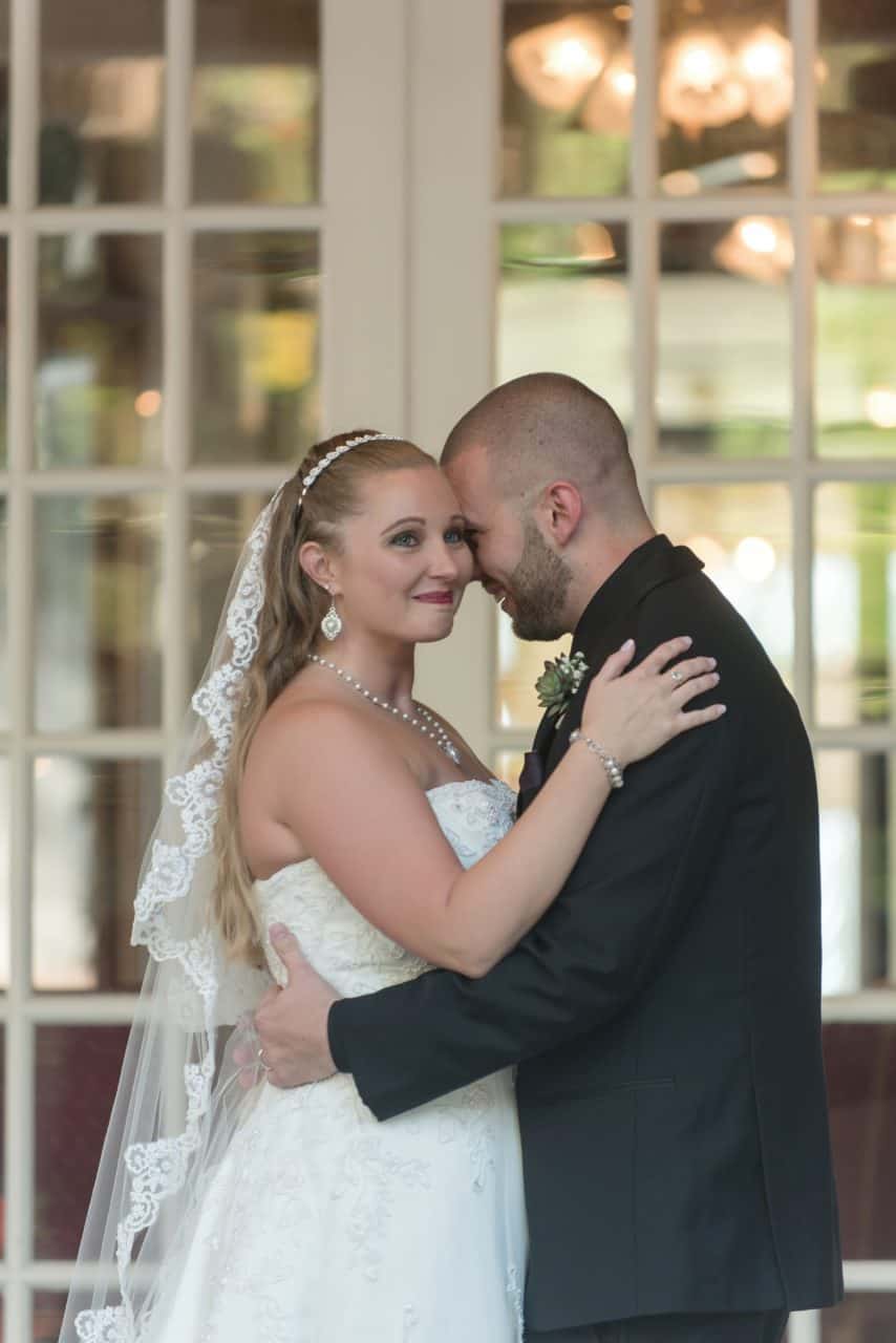 Couple embraces during wedding Photos
