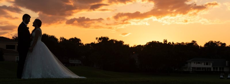 Couples portrait at sunset on the country club golf course