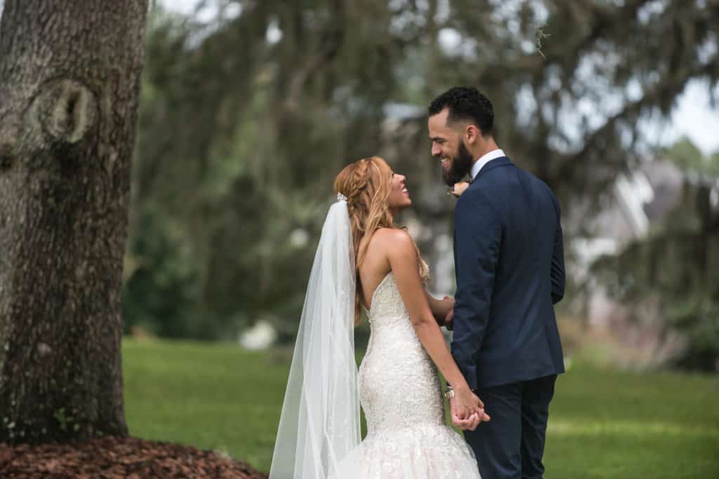 Groom smiles at Bride outdoors in Orlando Florida - The Best Wedding Venues Orlando has to offer