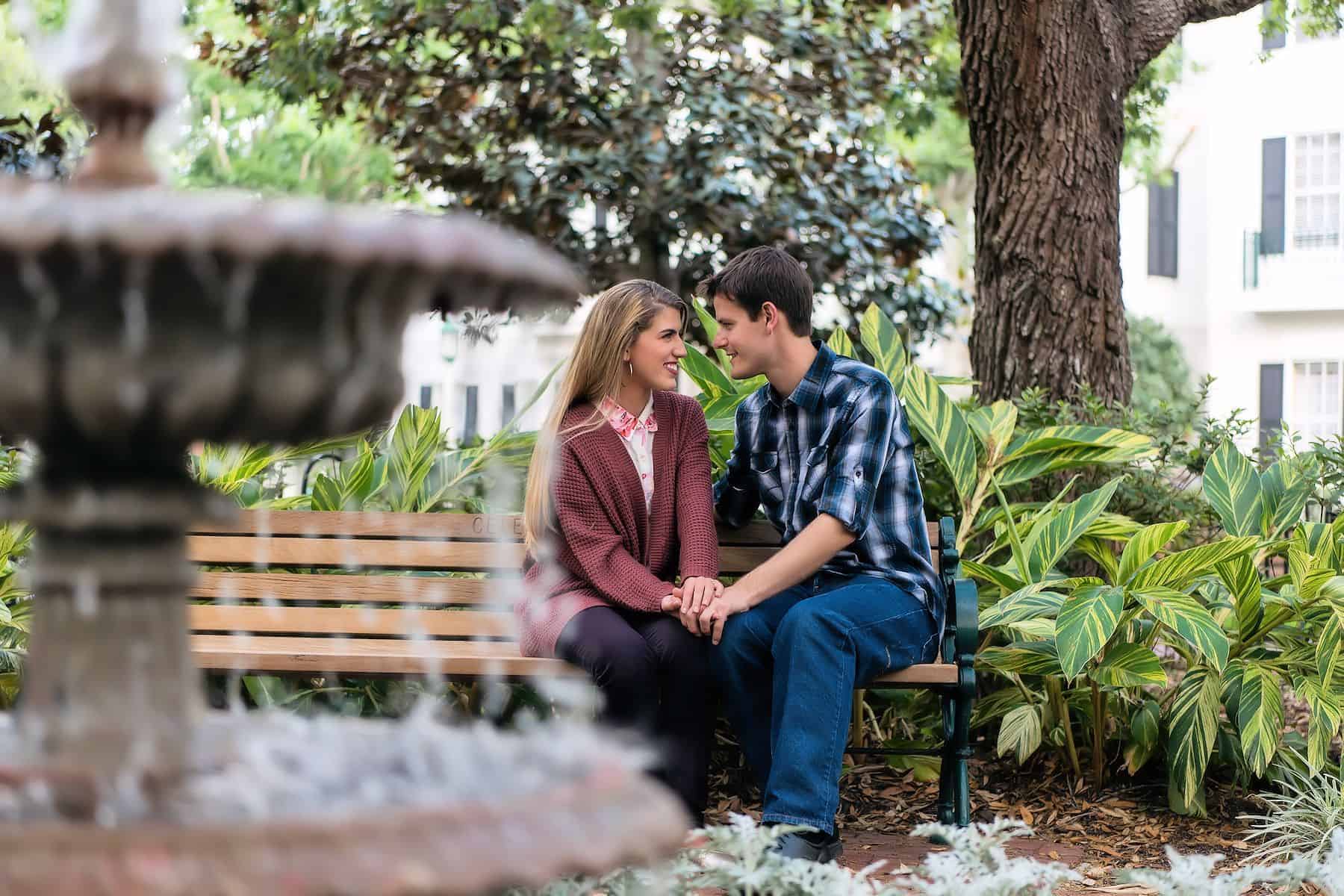 Couple on bench by fountain in an Orlando Engagement Session Location